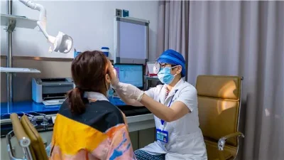Clinician carrying out an examination in a hospital consultation room