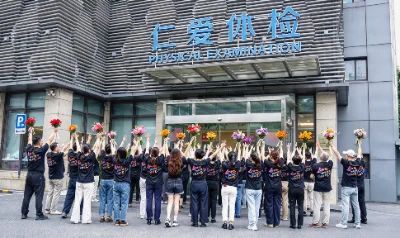 A group holding flowers outside Ren’ai Hospital’s check-up centre.