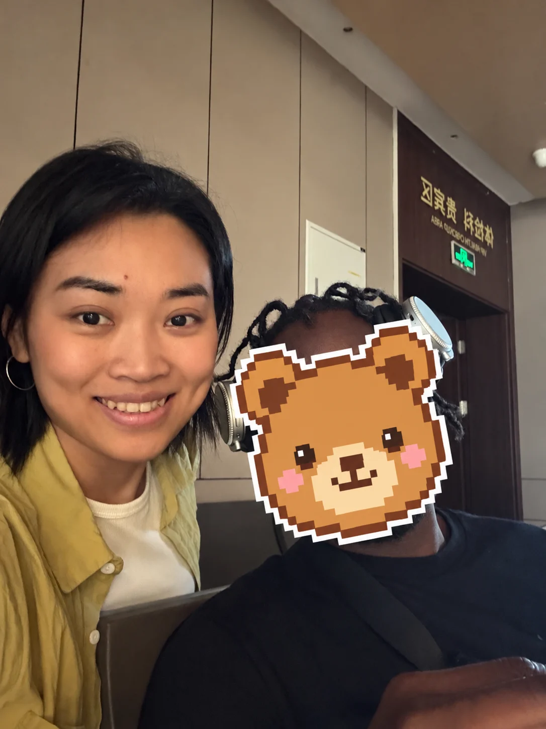Bella and a visitor whose face is covered by a pixel-bear sticker at Clifford Hospital in Guangzhou