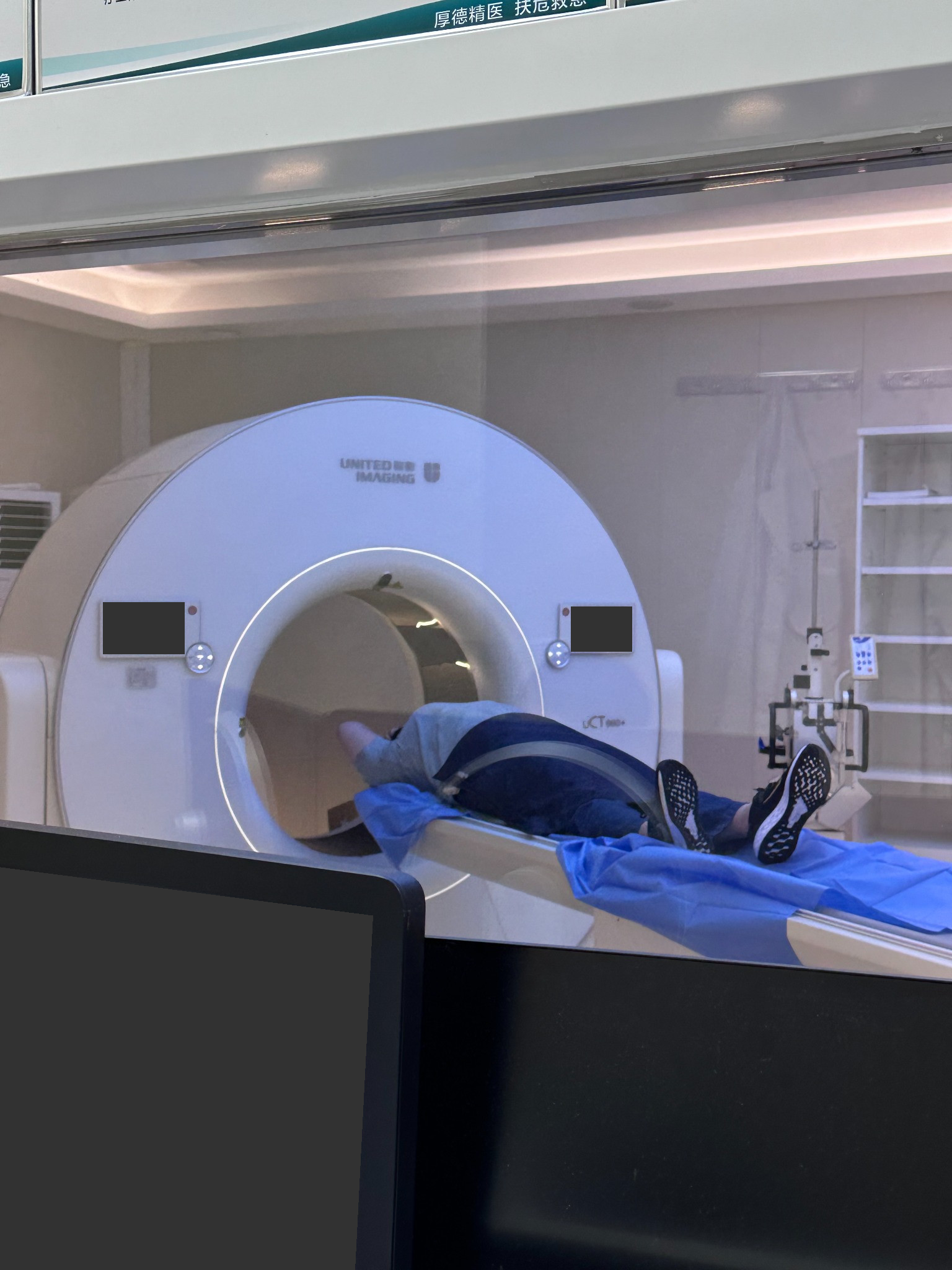 A CT examination room during the visit, with screen information obscured