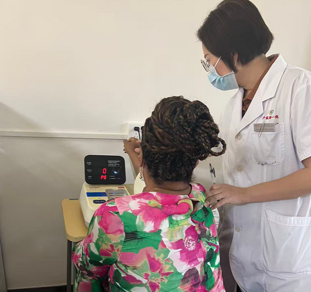 Hospital staff assisting the visitor during the Guangzhou check-up visit on 12 October 2026