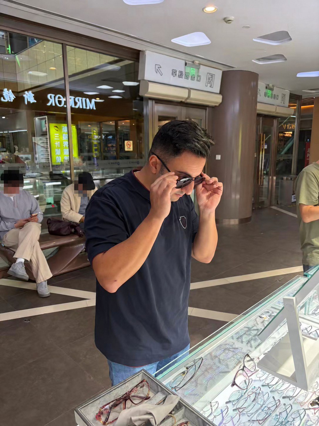 The visitor trying on glasses at an optical store in Shanghai