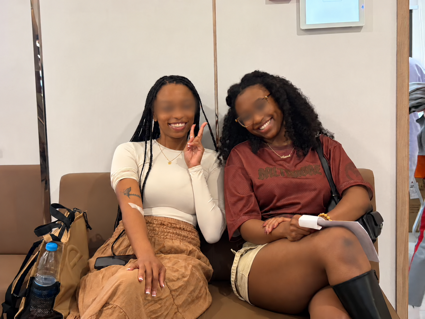 Two friends in the Shanghai hospital waiting area, with facial areas lightly blurred for privacy